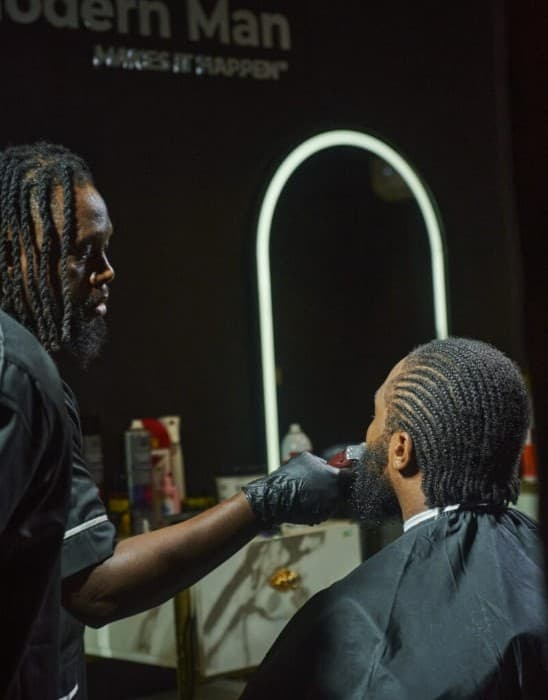 Professional barber giving a signature haircut to a client